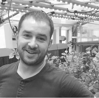 Dr. Philip Crim in a plant research greenhouse